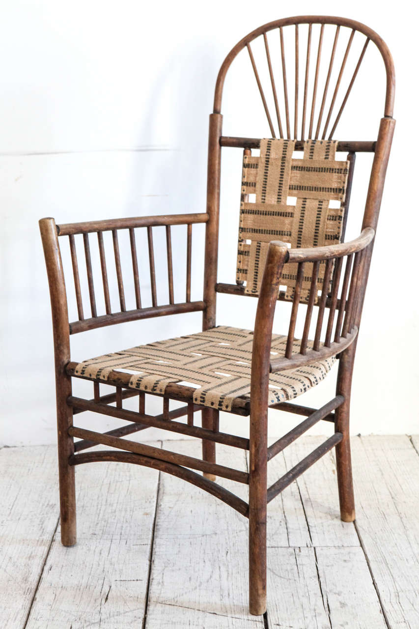 Striking silhouette Windsor style arm chair newly woven with burlap and black stripe fabric.