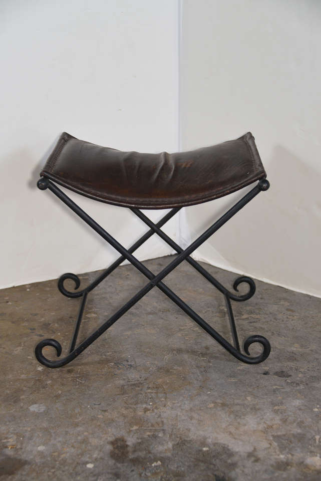 French early 1900s  or earlier hand forged iron bench with original leather seat cushion.  Very chic....