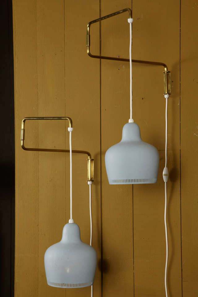 RARE PAIR OF PENDANT WALL SCONCES BY FINNISH THE DESIGNER ALVAR AALTO 1898-1976 
NICE PALE BLUE COLOR ON THE VARNISHED BELL SHADES AND BRASS SWING ARMS.