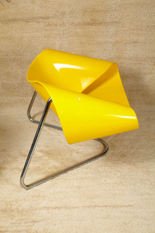 Painted yellow ribbon shaped, fibre-glass with chromed tubular steel base. Beautiful design.