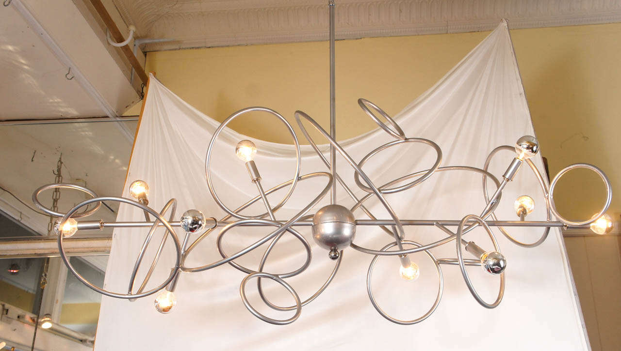 A handcrafted custom steel and brass chandelier made to order. It is available in many colors, combinations and sizes.