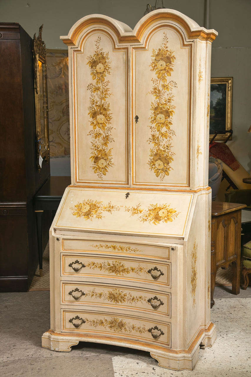 A fine paint decorated secretary desk, Italian. The double bookcase top over a drop front with an interior desk. The lower section of drawers. Finely painted with flowers, vine and leaf decoration.