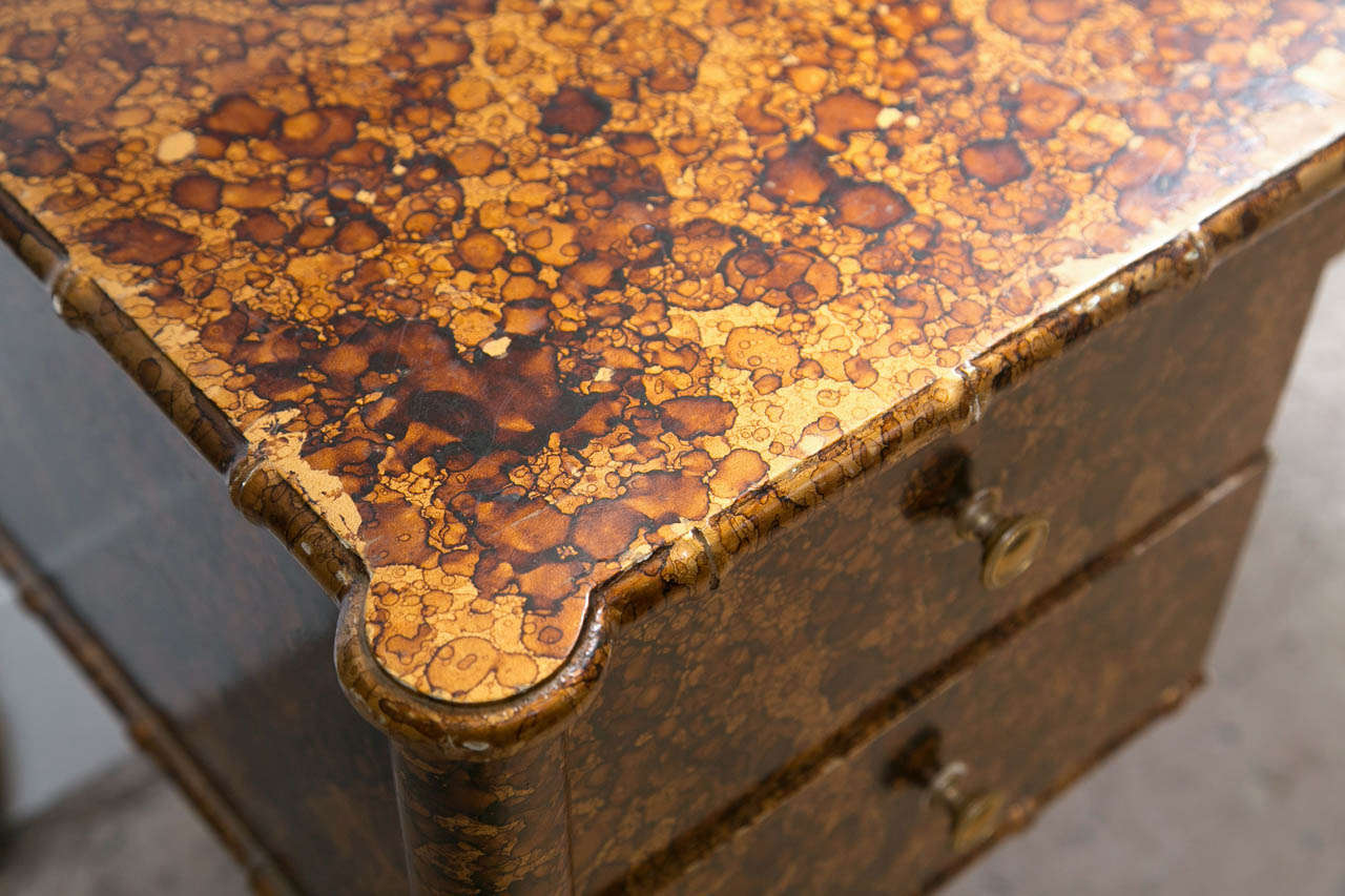 A tortoise shell faux finish bamboo desk. Wonderful Hollywood Regency look to this curved legged knee hole desk with Faux finish. The overall casing having five drawers and a finely finished back.