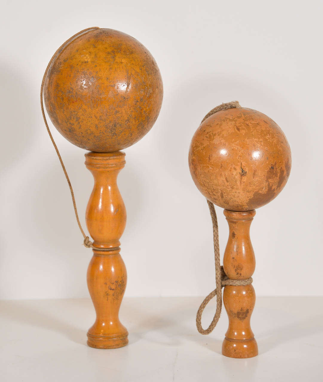 19th century Belgium hand-carved child's toy. the wooden ball is attached to the base with a woven string. The child would toss the ball off the base and try to catch it back on the base. The wooden ball has a hole in the bottom and the stand has a