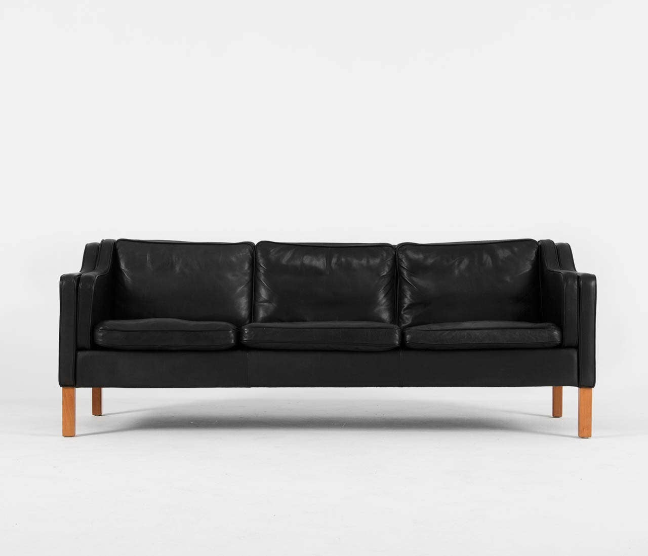 Very well conditioned black 3 seater sofa in the style of Borge Mogenson. This design comes from the 1960's and has wonderful shapes and comfort. The leather is in superb condition.

The high legs still provide an open look to the sofa although it