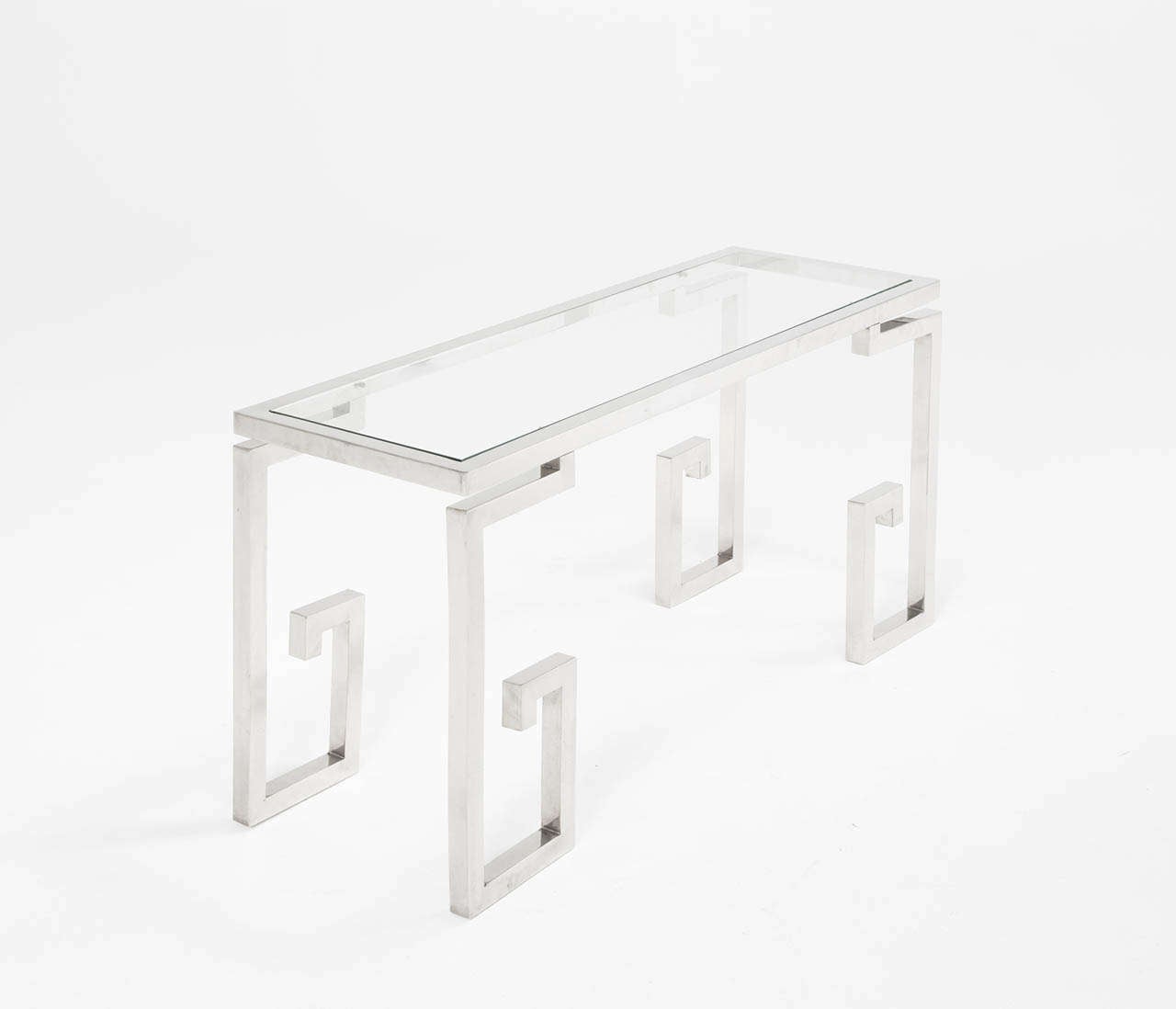Wall console in chrome and glass, France, 1970s.

Rectangular clear glass top with four G-shaped or curled legs. The clear glass nicely reflects the shimmer of the chrome.

We offer a variety of services, high service white glove shipping,