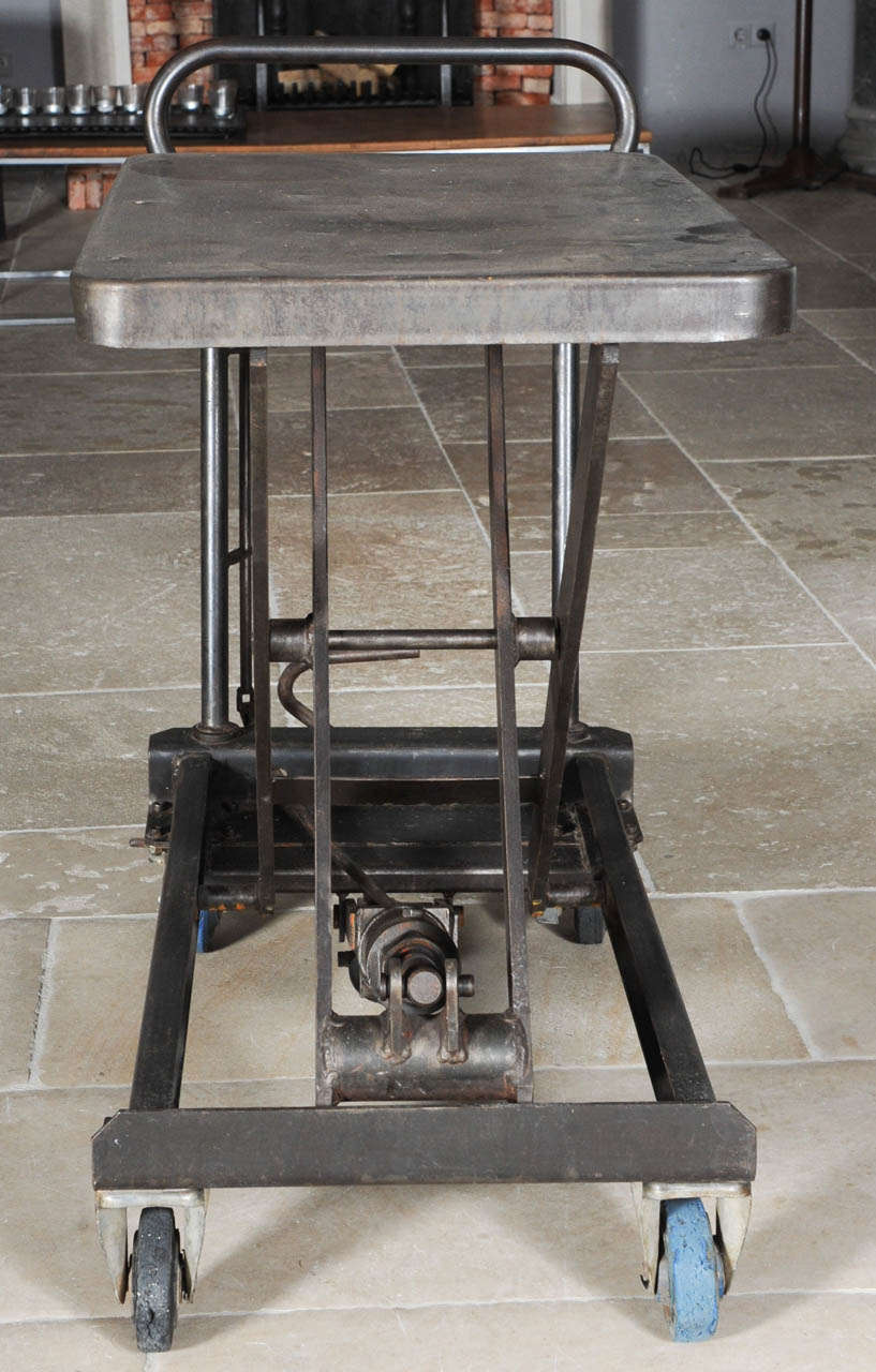 Industrial wrought iron sidetable with hydraulic (working) lifting system, polished steel scissor table.