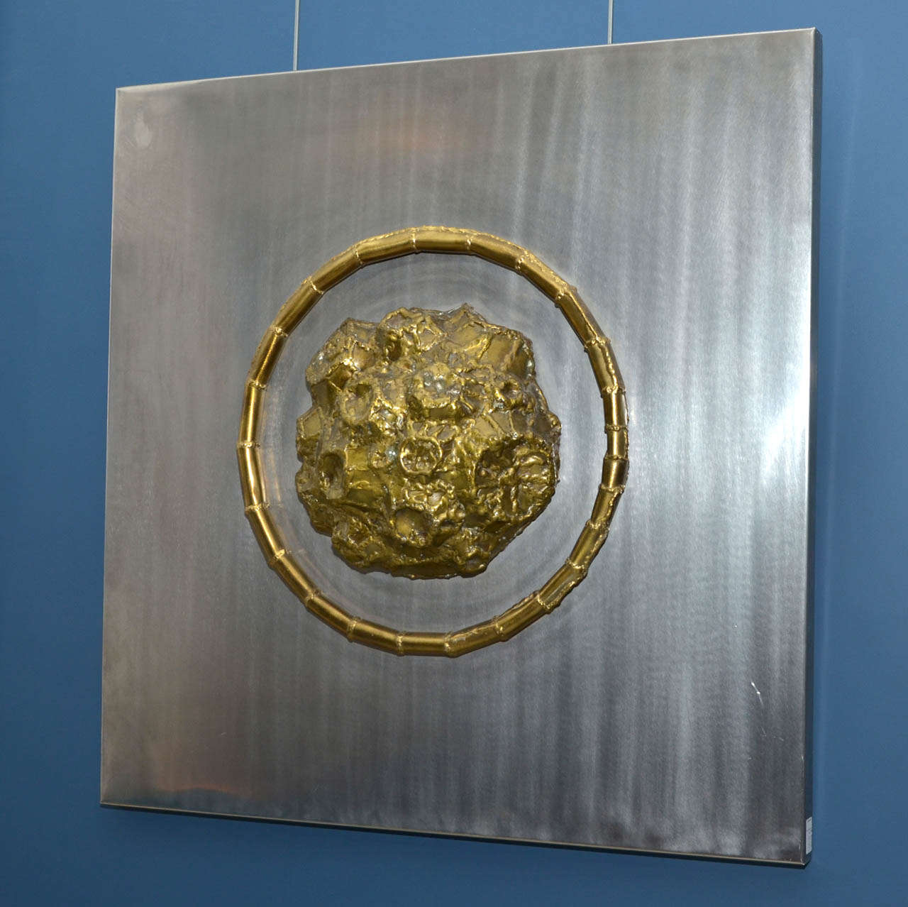 1969 panel sculpture signed Duval-Brasseur. Created by Jacques Duval-Brasseur. Stainless steel panel and brass meteorite sculpture. Normal wear consistent with age and use.