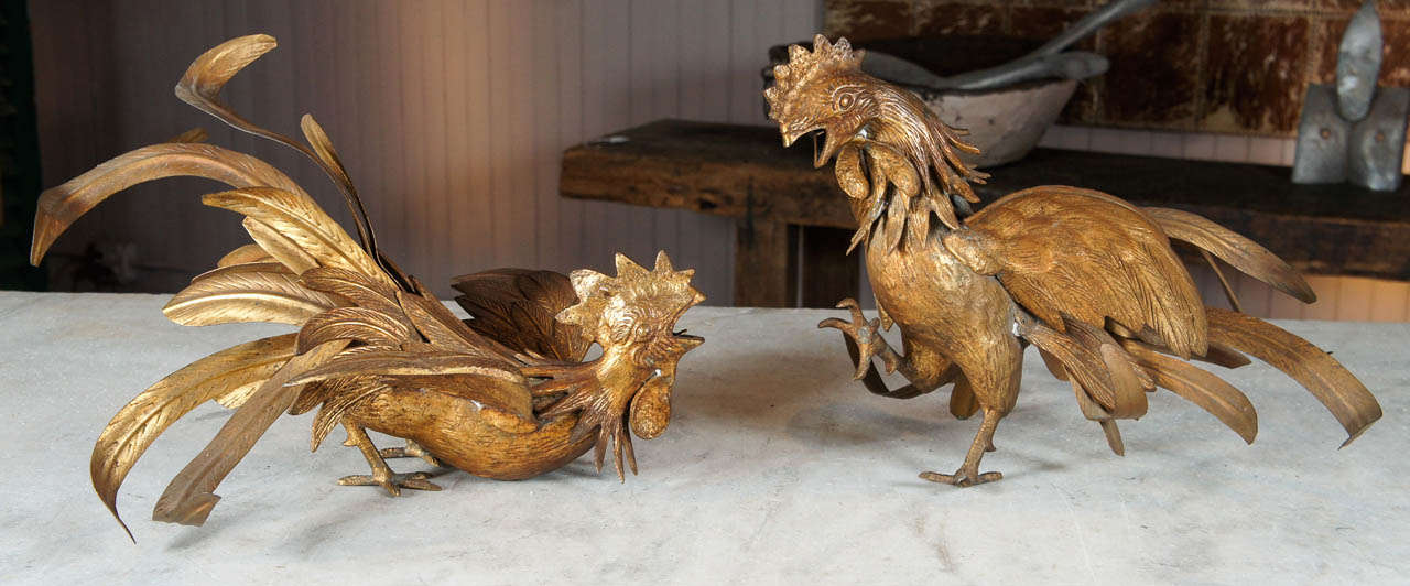 Pair of animated gilt metal fighting roosters. Timeless subject matter.