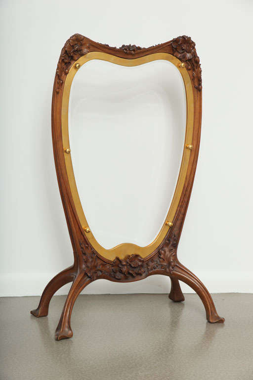A French Art Nouveau carved mahogany fire screen by