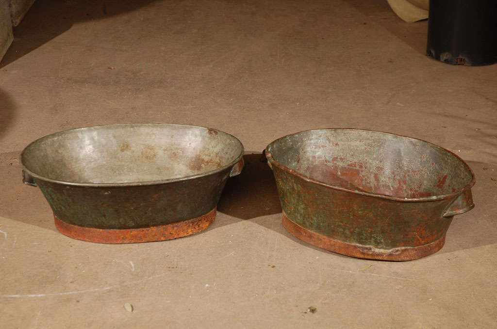 Pair of copper wash basins with iron bases