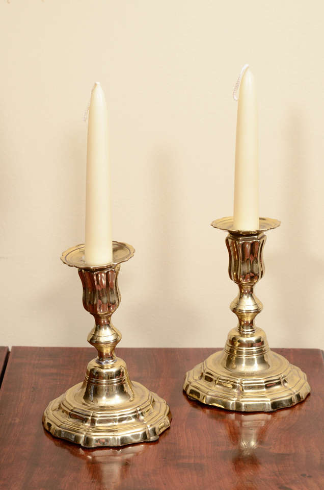 A pair of Dutch brass candle sticks in the Rococo style 