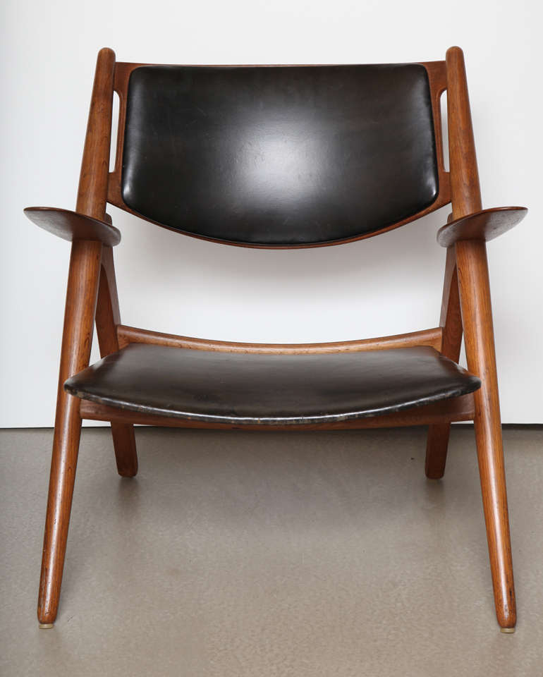 A Danish oak and leather armchair.

Designed by Hans Wegner

Name - Sawbuck chair

Model Number - CH-28 armchair was designed by Hans Wegner in 1951 and was one of the first five designs he created for Carl Hansen & Son. 

Early production