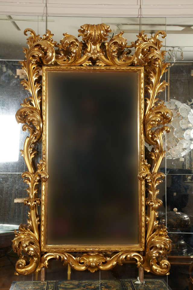Pair of richely sculpted giltwood mirrors, ancient mercury glass, Italian baroque style, entirely restored in the original technic system