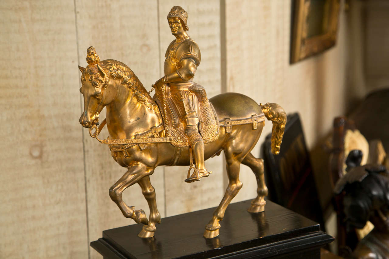 a reproduction  of the original  by Andrea del Verrocchio done  sometimes between 1483 and 1488.  Colleoni almost  standing upright in  the stirrups, the rippled muscles of the horse evident. The horse's front left leg raised , the right  rear leg