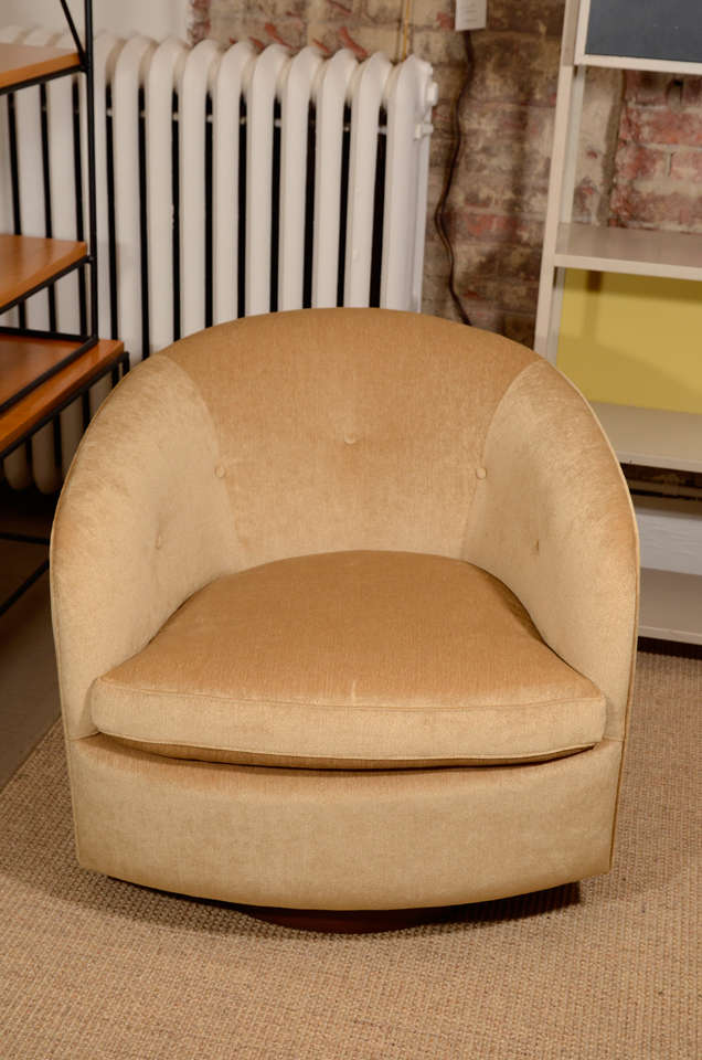 Pair of button backed lounge chairs on walnut swivel base, mfg. Available COM. Each chair requires 6 yards of fabric.