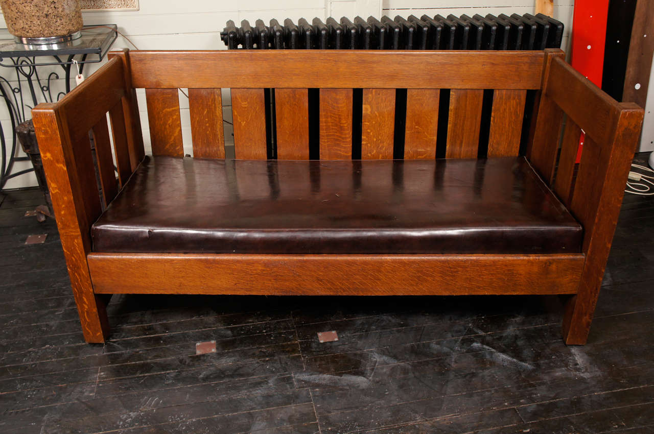 Tiger striped oak settle with wide slats and original spring box seat. 