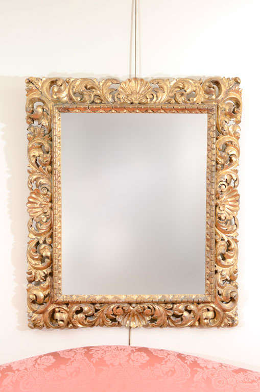 Beautifully carved large giltwood frame with shell and leaf motifs.

circa 1800 in later mirror glass.