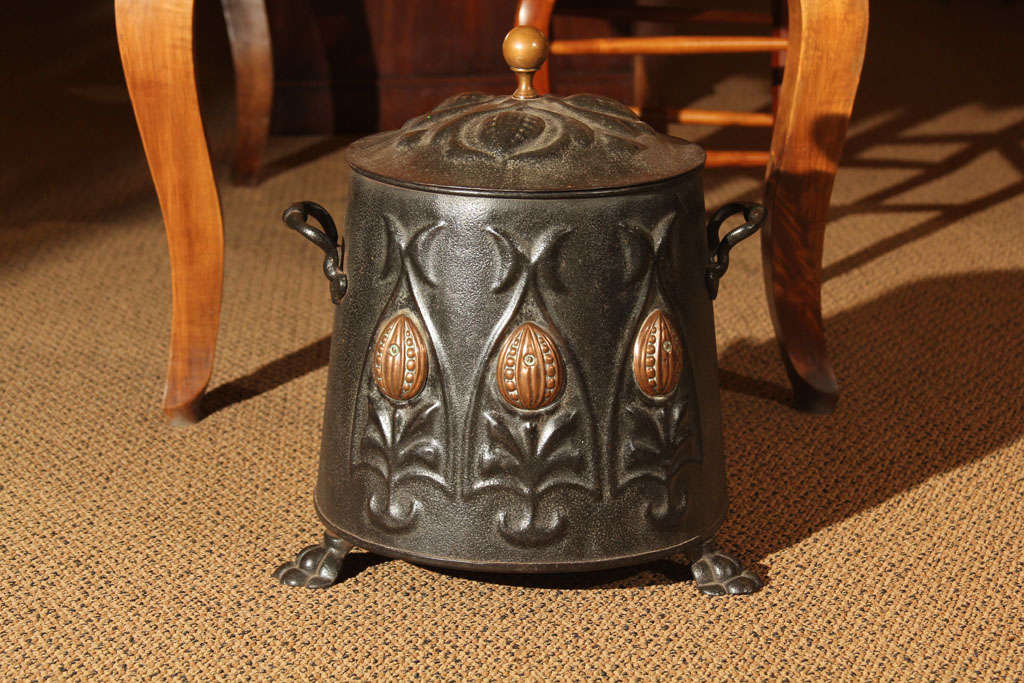 English Steel and Brass Coal Scuttle

This is an English coal scuttle with the original lid, handles and feet.  It features the walnut decoration on the front and the lion's paw feet.

On the inside there is an old pail for carrying the coal.