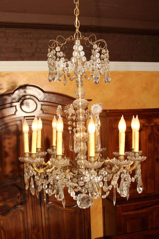 French Napoleon III Twelve-Arm Chandelier

This is a grand chandlier with twelve candleabra lights.  Above the main set of lights is a decorative section of crystals that gives this fixture a lot of impact. 

The bronze work has the appearance