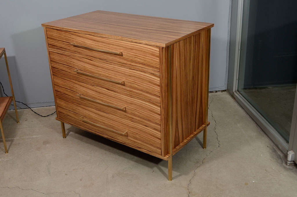 Zebra wood dresser with brass handles and details.