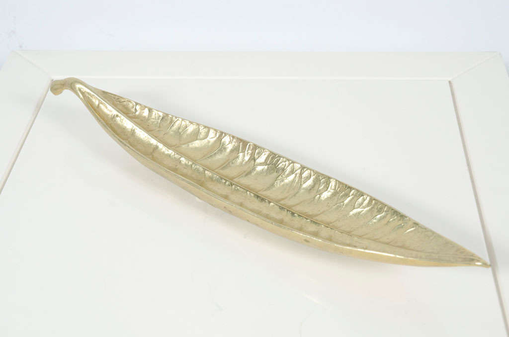 A brass dish in the form of a Euphorbia Codiaeum leaf.  Signed to the base with manufacturer's cipher and 