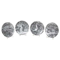 A set of four porcelain plates by Piero Fornasetti A set of four porcelain plates by Piero Fornasetti