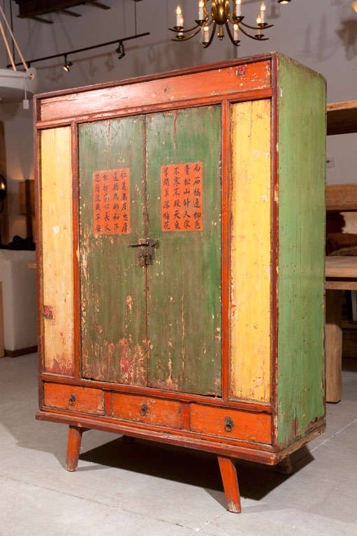VIvid original colours dictate this early 19th century cupboard