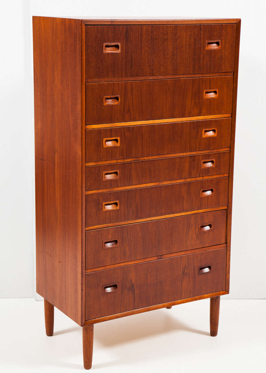 Vintage 1960s Teak Tallboy Dresser from Denmark

This Danish Modern Chest of Drawers is in like-new condition. The interior of the drawers are built from mahogany wood which offers extra protection since mahogany is a natural bug repellent. Seven