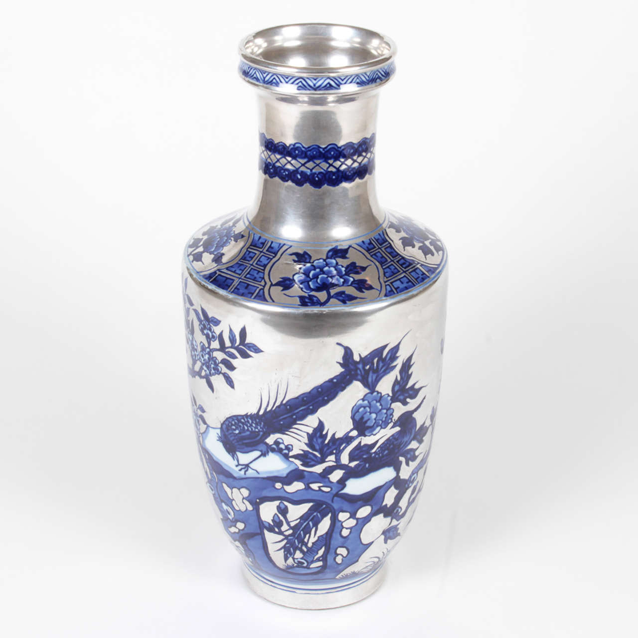Vintage silver Chinese vase with hand-painted details in striking blue. The vibrant colors make this item modern with a traditional motif. The tapered stem adds an elegant touch to flower arrangement.