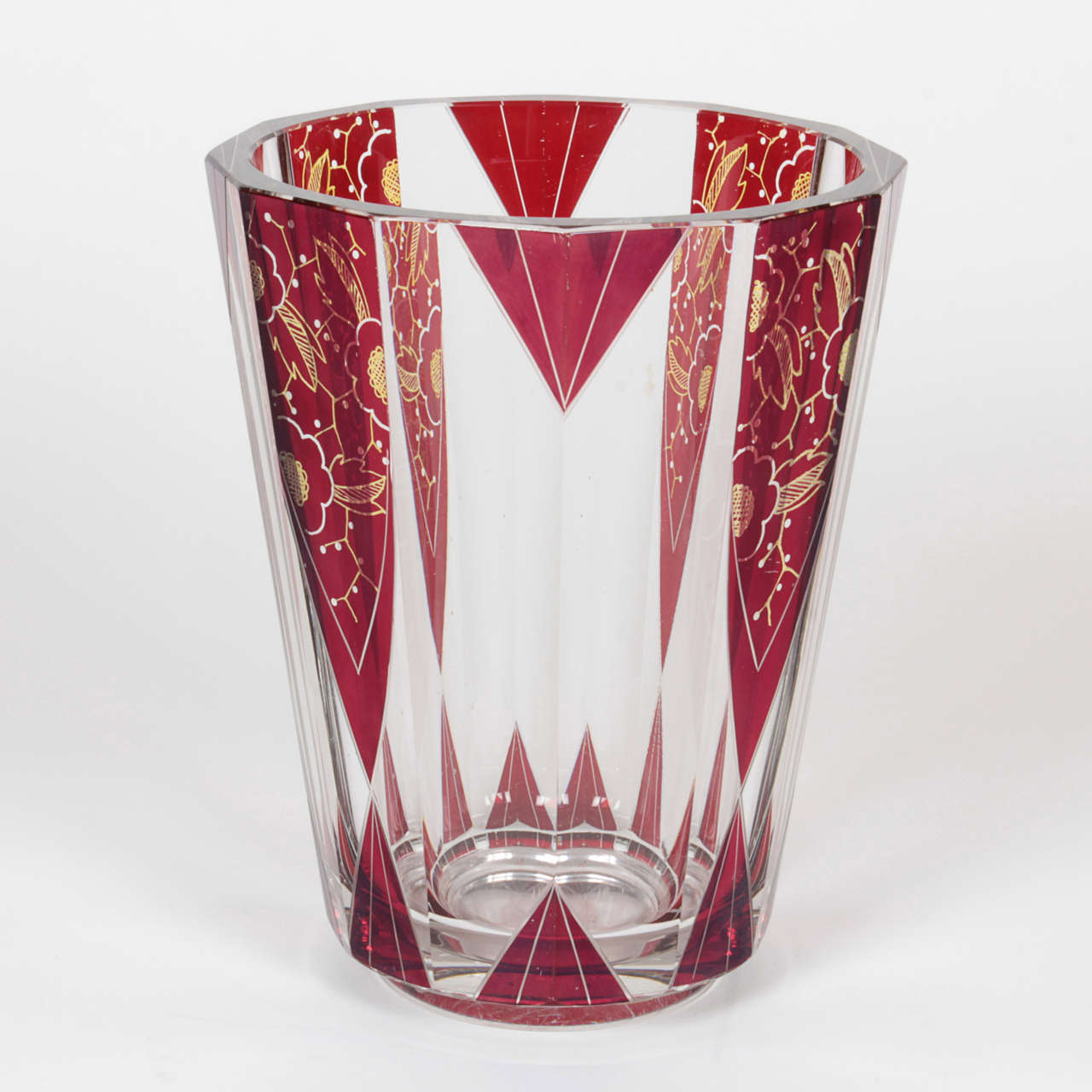 Vintage Czech Art Deco clear and ruby vase in striking pattern. Multifaceted piece has rare red coloring with gold detail.