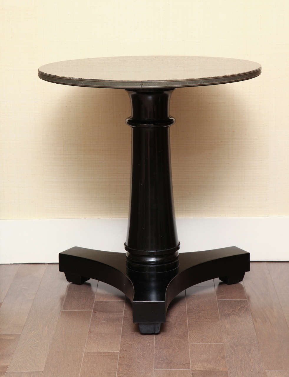 Black lacquer classical pedestal side table with brass trim, circa 1960s.