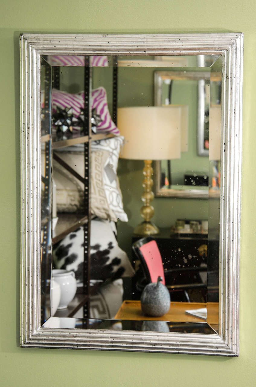 A pair of nice looking silvered wood mirrors with reeded frame and beveled glass.