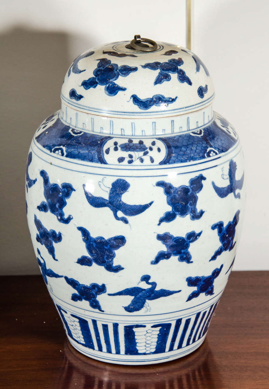 A near pair of Chinese export porcelain ginger jars with lids. The pair is almost identical, except for the top band on jar under lid. One is a more solid design, the other a more open design.