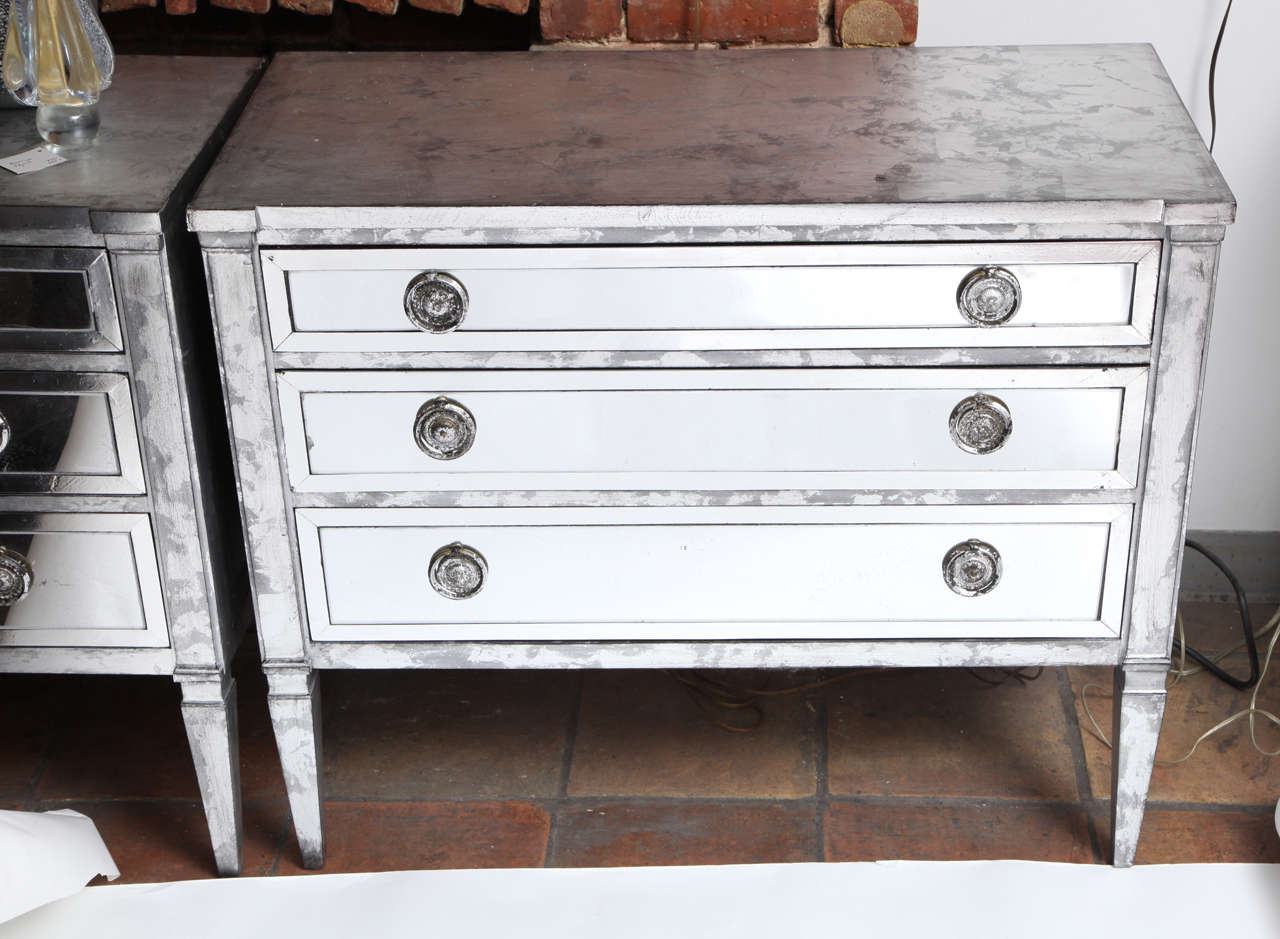 A wonderful and practical pair of silvered and mirrored three-drawer chests. Marked in the top draw The Contessa Collection by the furniture company John Stuart.