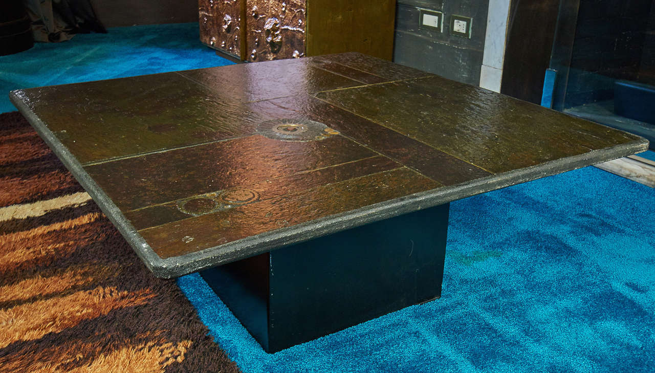 Concrete top decorated with stone slices and brass details, black iron base.