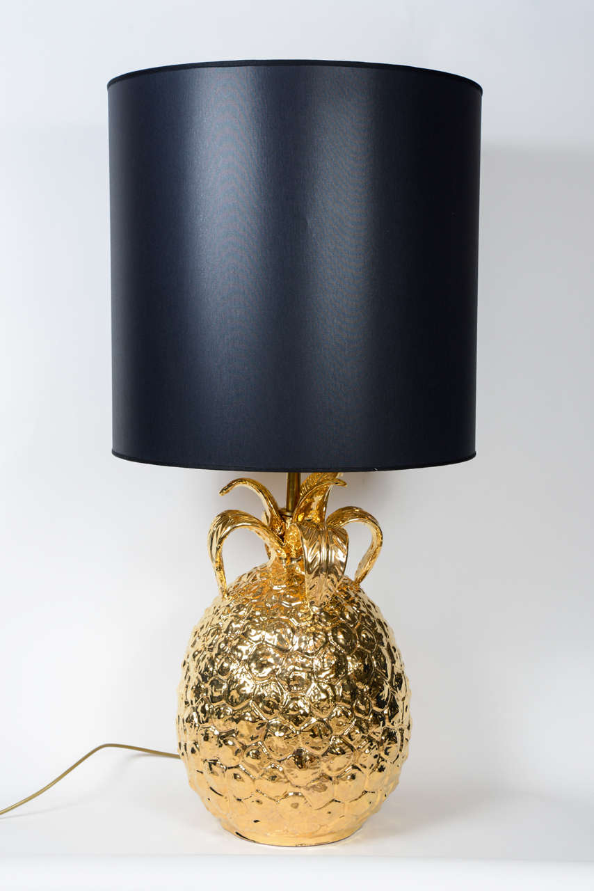Pair of big pineapple shaped ceramic lamps painted in gold.

Dimensions without the shades.