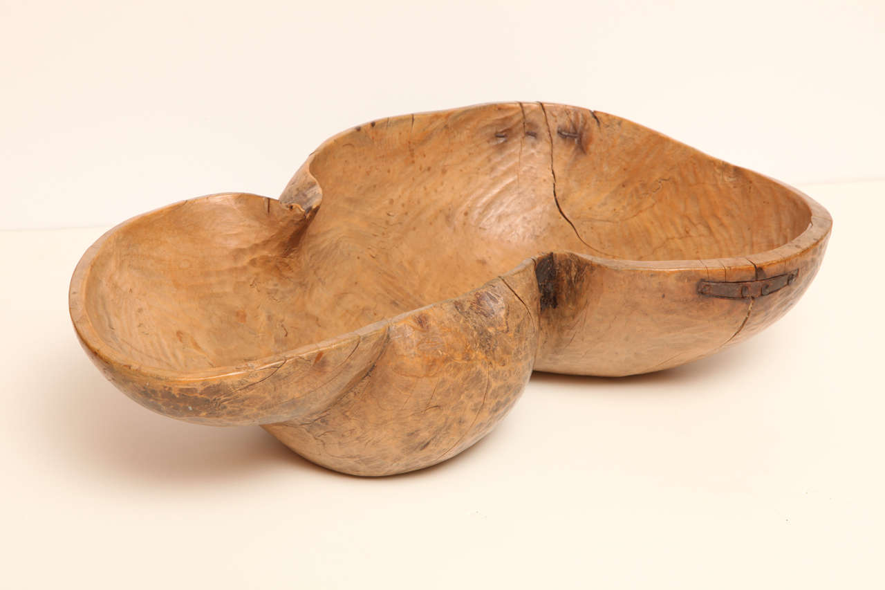 Signed “OPS” and dated 1823, this highly unusual and large Swedish bowl was hewn from the burled wood of a tree root. External crevices bear traces of bark and two small splits were reinforced with period iron tabs held in place by handmade nails.