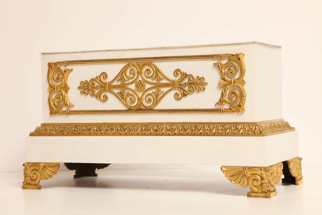 A French Empire planter with finely chiseled gilt bronzes that are mounted to the original but repainted sheet metal base. A wood brace underneath is inscribed 