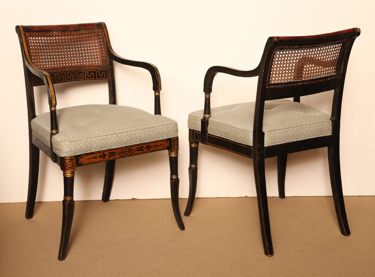 Pair of early 19th century English Regency neoclassical caned armchairs.