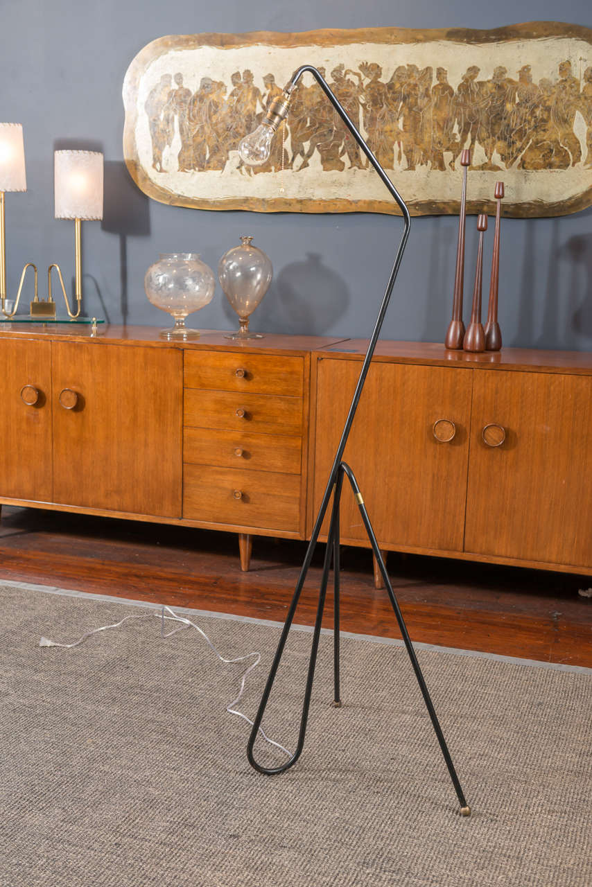 Minimalist mid-century modern wrought iron floor lamp with brass ball feet. 
Excellent original condition, newly re-wired.