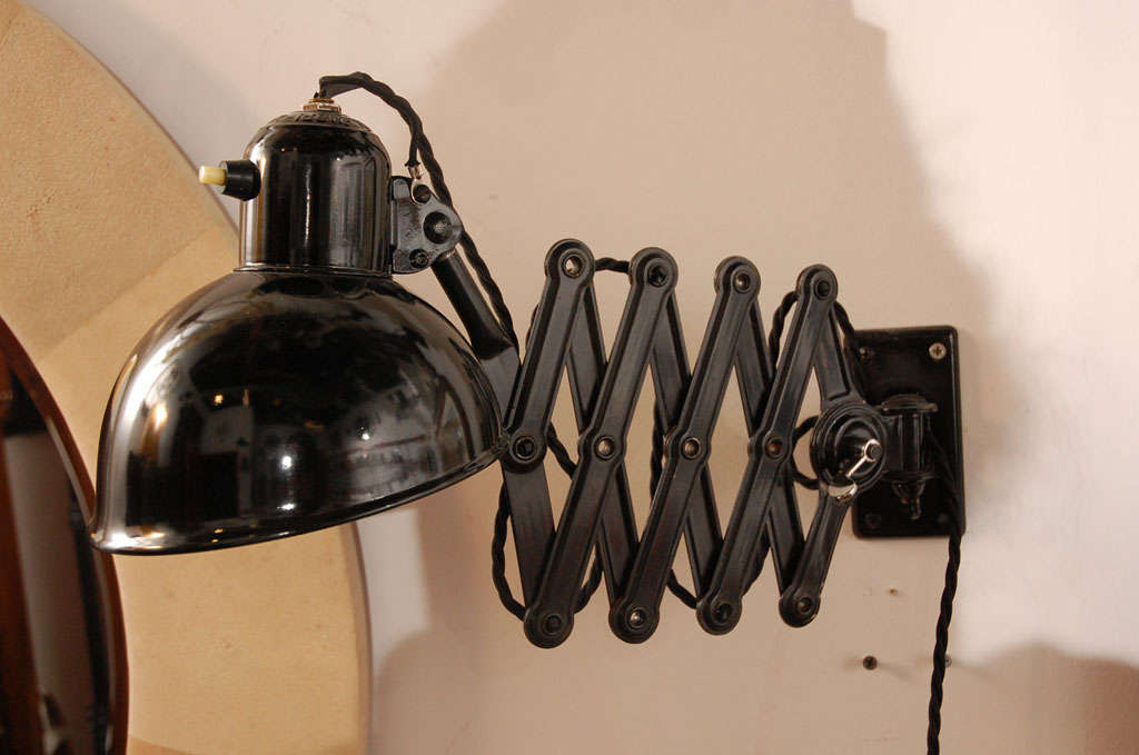 Black painted metal accordion wall lamp by Christian Dell.