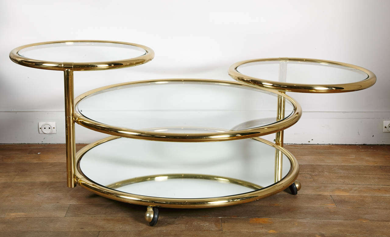 A chic, barss, circular coffee table,
the bootom tier is mirrored, 
the 2 top tiers swivel to a maximum of 178cm (70
