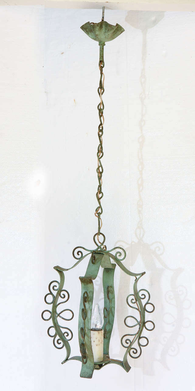 Charming hand wrought iron hanging light with verdigris finish.
Single light. Original ceiling cap and chain.  Ready for installation. 

Fixture is 17