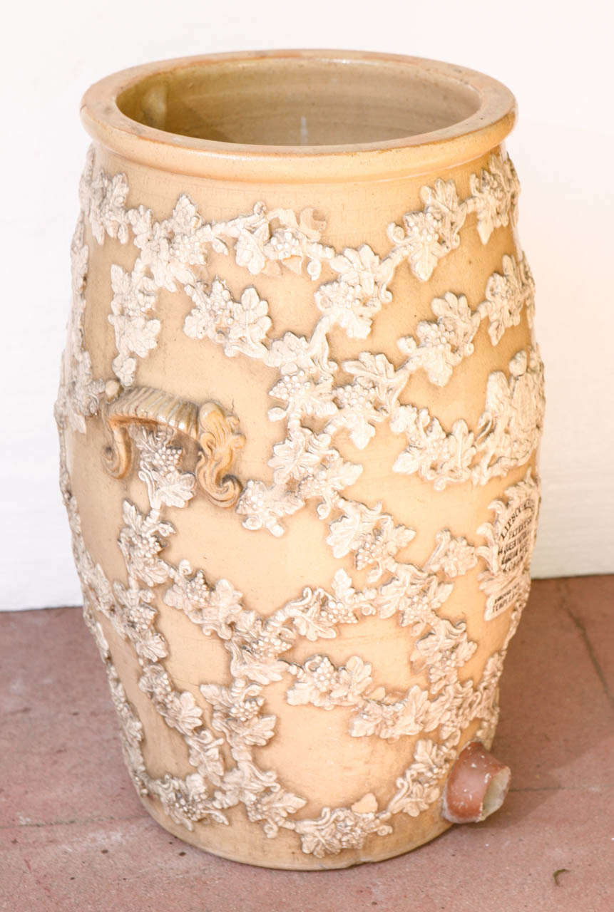 A large English stoneware water filter with foliate slipware applique in a contrasting color. Charcoal was added to the top and water filtered through for purification. Center diameter is 16