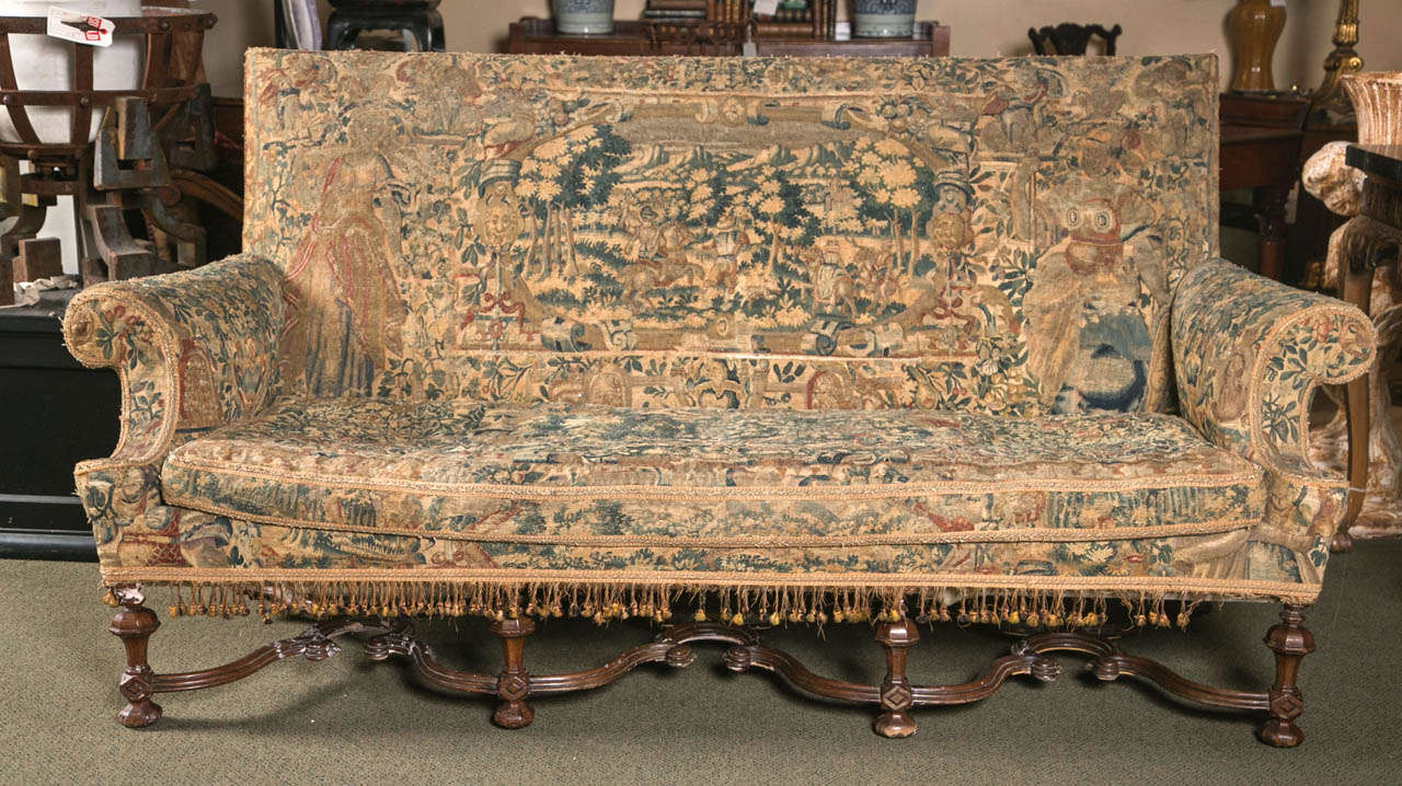 An English William & Mary style high back settee, nicely upholstered in 17th/18th century Flemish tapestry.
