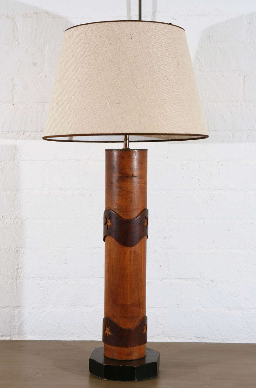 Lamp made from a wood wallpaper roll, originally used to print wall paper. This piece is a nice example of early 20th century craftsmanship with it's carved wooden patterning in a simple refined rustic style. Fitted with new wiring and fixture.