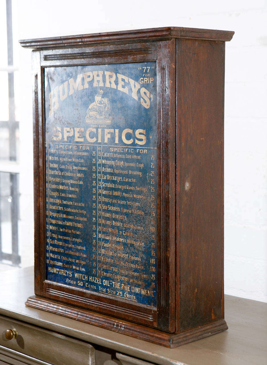 This Humphreys' Homeopathic Medicine Company Apothecary cabinet from the 1870's has incredible details including a painted metal door with the original brand type and indications for specific treatments. The interior has thirty four compartment