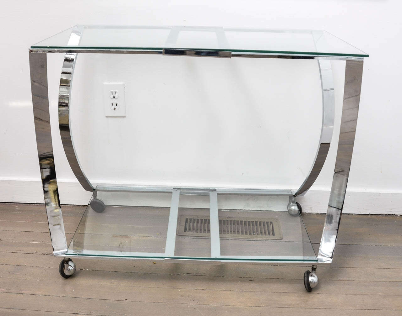 Wheeled two-tier chrome and glass bar cart.