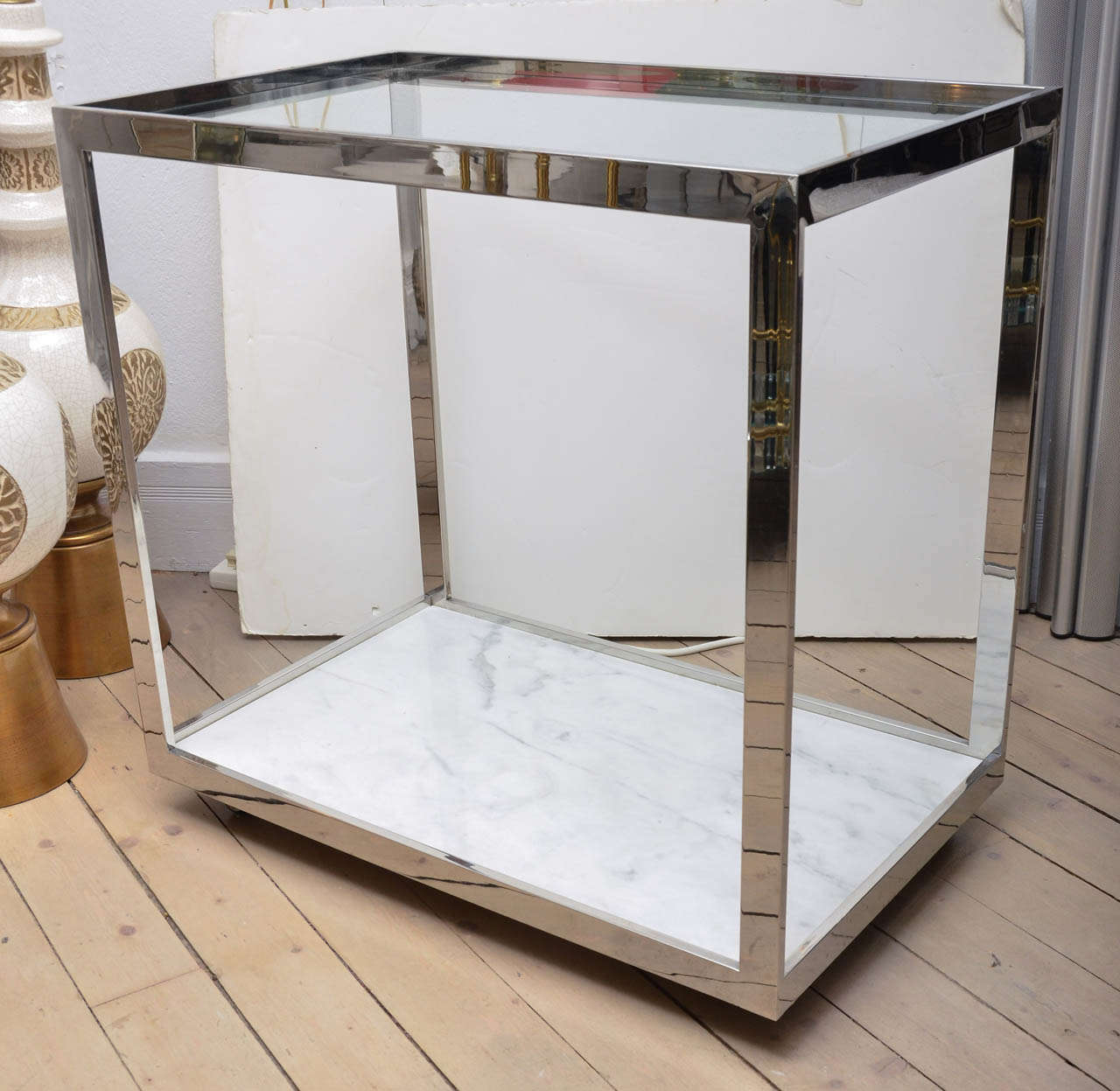 illustrious American designer Milo Baughman created this wheeled bar cart with chromed steel and a marble bottom and clear glass top!